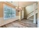 Dining room with hardwood floors with staircase and front door in view at 3733 Sidney Lanier Blvd, Duluth, GA 30096