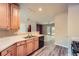 Open kitchen with light wood cabinets, stainless steel sink, modern appliances, and luxury vinyl plank flooring at 3733 Sidney Lanier Blvd, Duluth, GA 30096