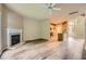 Spacious living room featuring hardwood floors, fireplace, and kitchen access at 3733 Sidney Lanier Blvd, Duluth, GA 30096