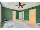 Spacious main bedroom with tray ceiling, ceiling fan, carpet, and access to en suite bath and walk-in closet at 3733 Sidney Lanier Blvd, Duluth, GA 30096