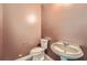 Powder room featuring tiled flooring, a pedestal sink, and a single toilet at 3733 Sidney Lanier Blvd, Duluth, GA 30096