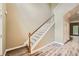 Bright foyer with staircase featuring wood handrail and gray carpet steps at 3733 Sidney Lanier Blvd, Duluth, GA 30096