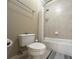 Bathroom featuring a tub with shower, toilet, and grey striped rug at 608 Tabbystone Nw St, Marietta, GA 30064