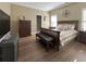 Cozy bedroom featuring hardwood floors, a dark wood bed frame and a black leather bench at 608 Tabbystone Nw St, Marietta, GA 30064