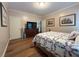 Bedroom with hardwood floors, dresser, and view of the hallway at 608 Tabbystone Nw St, Marietta, GA 30064