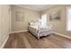 Bedroom featuring light-colored walls and hardwood floors, filled with natural light at 608 Tabbystone Nw St, Marietta, GA 30064
