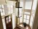 Bright foyer with high ceilings, large windows, a hanging light fixture, and a wooden front door at 608 Tabbystone Nw St, Marietta, GA 30064