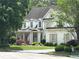 Elegant white home with an American flag, covered front porch, and meticulously kept front yard at 608 Tabbystone Nw St, Marietta, GA 30064