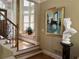 Hallway with hardwood floors, elegant staircase, and artwork, creating a welcoming atmosphere at 608 Tabbystone Nw St, Marietta, GA 30064