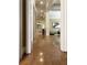 Hallway featuring hardwood floors, decorative columns, artwork, and a glimpse into the living room at 608 Tabbystone Nw St, Marietta, GA 30064