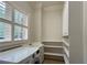 Convenient laundry room with a sink, storage cabinets, and a window for natural light at 608 Tabbystone Nw St, Marietta, GA 30064