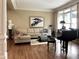 Living room with a sofa, piano, and artwork creating a harmonious living space at 608 Tabbystone Nw St, Marietta, GA 30064