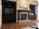 Cozy living room showcases a stone fireplace, built-in cabinets, and dark trim at 608 Tabbystone Nw St, Marietta, GA 30064
