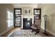 Cozy office with a fireplace, built-in bookcases, and a comfortable rocking chair at 608 Tabbystone Nw St, Marietta, GA 30064