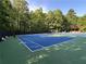 Outdoor tennis court surrounded by lush greenery, offering a perfect space for recreational activities at 608 Tabbystone Nw St, Marietta, GA 30064