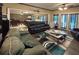 Spacious theater room with dark leather sofas, ceiling fans, and hardwood floors at 608 Tabbystone Nw St, Marietta, GA 30064