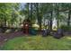 Spacious backyard with playset, lounge chairs, and picturesque tree line at 615 Wilson Nw Rd, Atlanta, GA 30318