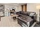 Spacious finished basement with a comfortable seating area and an adjacent work area at 615 Wilson Nw Rd, Atlanta, GA 30318