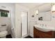 Bright bathroom with a tiled shower, decorative sconces, and modern fixtures at 615 Wilson Nw Rd, Atlanta, GA 30318