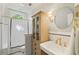Charming bathroom featuring a pedestal sink, decorative mirror, and classic subway tile at 615 Wilson Nw Rd, Atlanta, GA 30318