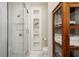 Bathroom featuring a glass shower, built-in shelving, and classic tile work at 615 Wilson Nw Rd, Atlanta, GA 30318