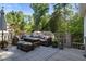 Outdoor deck featuring stylish seating, comfortable pillows, and scenic wooded views at 615 Wilson Nw Rd, Atlanta, GA 30318