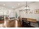 Bright dining area with a wood table, pendant lighting, and convenient access to the kitchen and outdoors at 615 Wilson Nw Rd, Atlanta, GA 30318