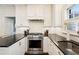 Well-equipped kitchen featuring stainless steel appliances, dark countertops, and ample cabinet space at 615 Wilson Nw Rd, Atlanta, GA 30318