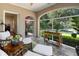 Inviting sunroom with floor-to-ceiling windows overlooking lush landscaping and comfortable seating at 615 Wilson Nw Rd, Atlanta, GA 30318