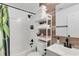 Modern bathroom showcasing a subway tile shower, wood accent wall, and ample storage at 1452 Mercer Ave, Atlanta, GA 30337