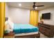 Sunlit bedroom featuring natural light, ceiling fan, and a TV at 1452 Mercer Ave, Atlanta, GA 30337