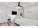 Bright bedroom featuring ceiling fan, TV and white furnishings at 1452 Mercer Ave, Atlanta, GA 30337