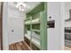 Cozy bunk bed nook with built-in lights, wood details and easy access to the kitchen at 1452 Mercer Ave, Atlanta, GA 30337