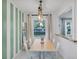 Bright dining room featuring stylish light fixture, view to front yard and natural light at 1452 Mercer Ave, Atlanta, GA 30337