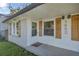 Close up of the front entrance featuring white brick and wooden shutters for windows and stylish lanterns at 1452 Mercer Ave, Atlanta, GA 30337