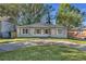 Charming single-story home with white brick exterior, wooden shutters, circular driveway, and well-manicured lawn at 1452 Mercer Ave, Atlanta, GA 30337