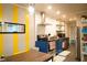 Charming kitchen with stainless steel appliances, blue cabinets, yellow accents and dining area at 1452 Mercer Ave, Atlanta, GA 30337