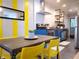 Modern kitchen with sleek appliances, yellow chairs and white subway tile backsplash at 1452 Mercer Ave, Atlanta, GA 30337