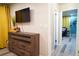 Inviting living room with TV, wood accents, and an adjacent hallway with colorful accents at 1452 Mercer Ave, Atlanta, GA 30337
