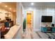 Open-concept living space with kitchen view, modern flooring, and entertainment center, creating a welcoming atmosphere at 1452 Mercer Ave, Atlanta, GA 30337