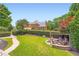 Expansive backyard features a stone firepit with seating and a lush green lawn at 692 Heritage Post Ln, Grayson, GA 30017