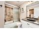 Bathroom featuring a tub/shower combo with tile surround, granite countertop and walk-in closet at 692 Heritage Post Ln, Grayson, GA 30017