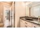 Bathroom with granite countertop, black sink, and tiled floor with an open doorway beyond at 692 Heritage Post Ln, Grayson, GA 30017