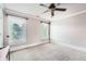 This bedroom features neutral walls, a ceiling fan, and two bright windows at 692 Heritage Post Ln, Grayson, GA 30017