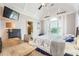 Bedroom featuring a desk, ceiling fan, large window and adjacent bathroom at 692 Heritage Post Ln, Grayson, GA 30017