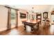 Billiard room with hardwood floors, a pool table, and large windows with window treatments at 692 Heritage Post Ln, Grayson, GA 30017