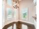 Light-filled breakfast nook with large windows, hardwood floors, and a stylish chandelier at 692 Heritage Post Ln, Grayson, GA 30017