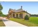 Community clubhouse with a covered entrance, beautiful windows, and manicured landscaping at 692 Heritage Post Ln, Grayson, GA 30017