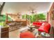 Covered patio with red brick accents, comfortable seating, and an outdoor ceiling fan at 692 Heritage Post Ln, Grayson, GA 30017