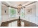 Elegant dining room featuring hardwood floors, wainscoting, and chandelier lighting at 692 Heritage Post Ln, Grayson, GA 30017